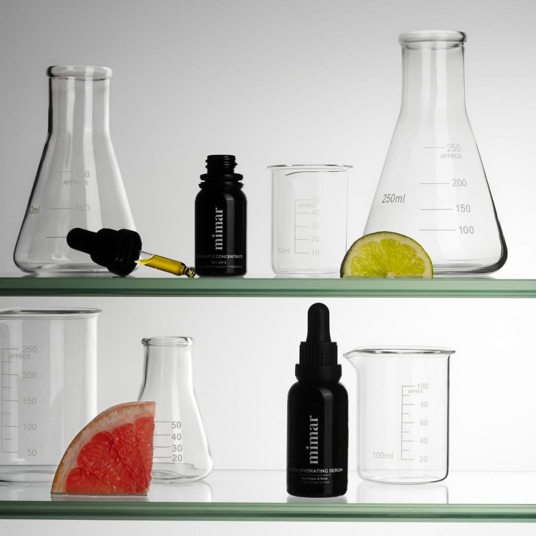Mimar Ultra Vit C Concentrate on lab shelves with glass beakers and citrus