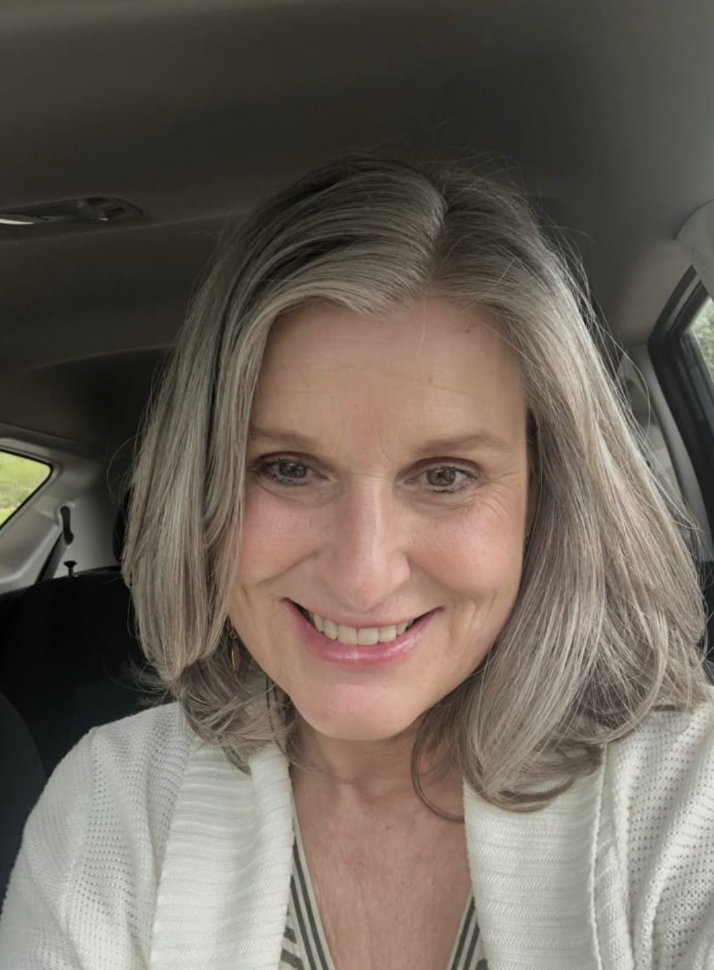Customer smiling in her car